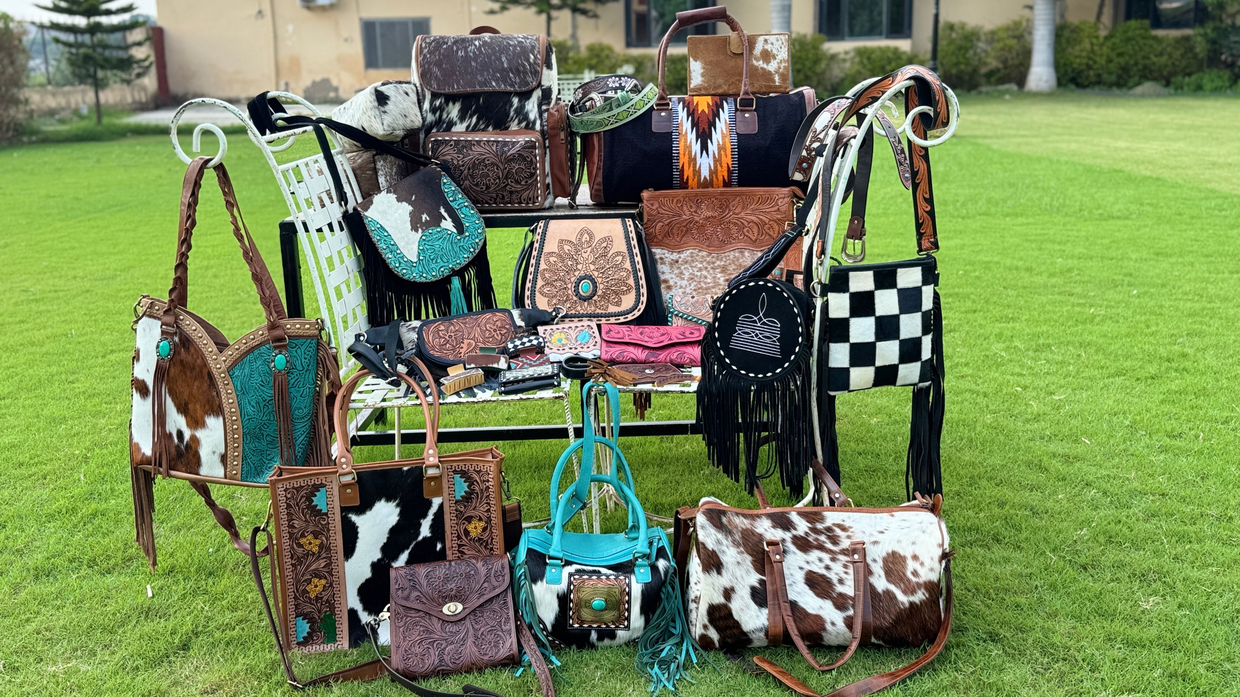 Collection of handbags with unique designs on a grassy area